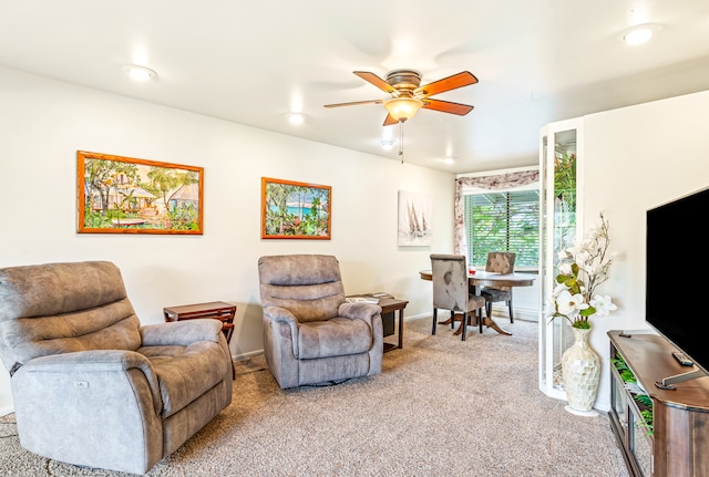 living room featuring carpet flooring and ceiling fan