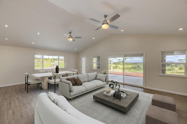 living room featuring hardwood / wood-style floors, high vaulted ceiling, and ceiling fan