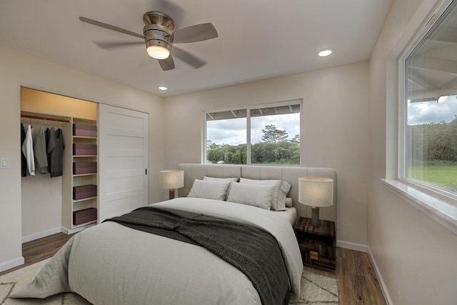 bedroom with ceiling fan, a closet, and wood-type flooring