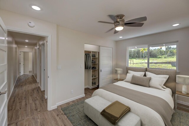 bedroom featuring ceiling fan, wood-type flooring, and a closet