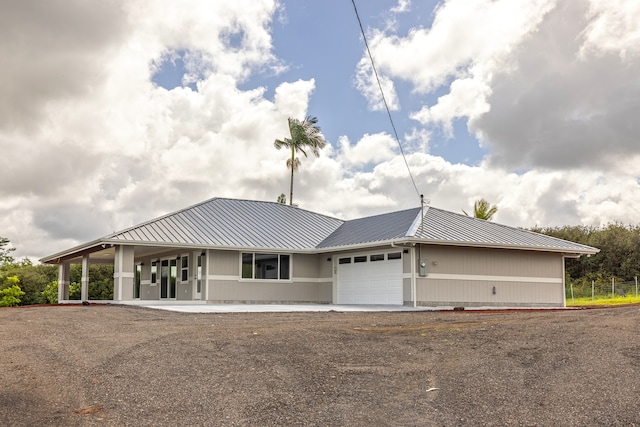 view of front of home featuring a porch and a garage