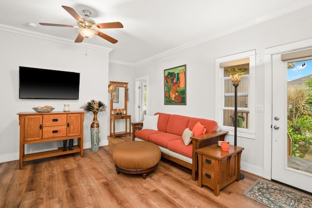 living room with hardwood / wood-style floors, ceiling fan, and crown molding