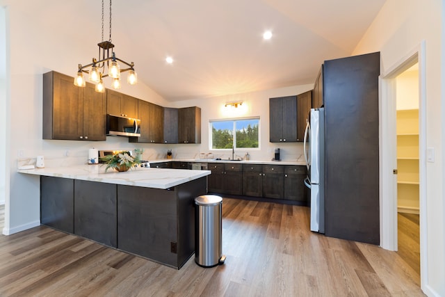 kitchen featuring kitchen peninsula, stainless steel appliances, light hardwood / wood-style flooring, and lofted ceiling