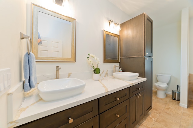 bathroom with tile patterned floors, vanity, and toilet