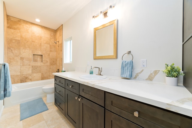 full bathroom featuring tile patterned flooring, vanity, tiled shower / bath combo, and toilet