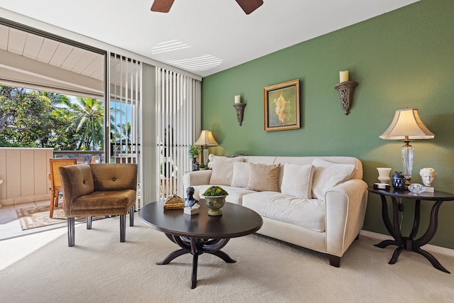 living room with ceiling fan, light colored carpet, and lofted ceiling