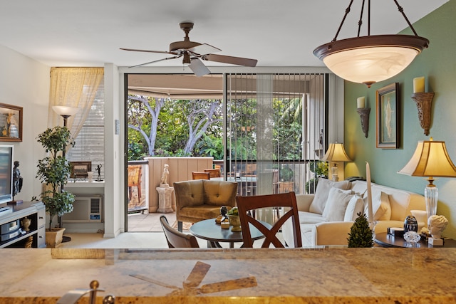 living room with plenty of natural light and ceiling fan