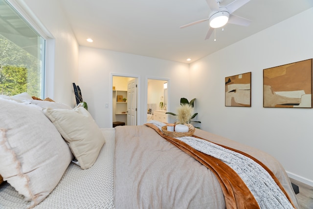 bedroom with ceiling fan, a spacious closet, and connected bathroom