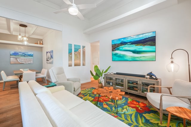 living room featuring wood-type flooring, ceiling fan, and beam ceiling