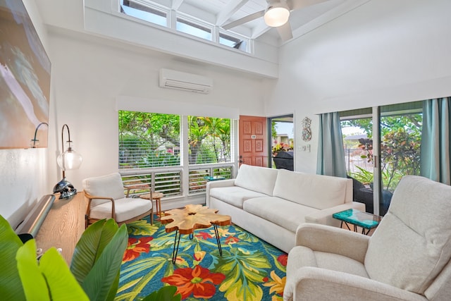 living room featuring beam ceiling, ceiling fan, a wall mounted AC, and a towering ceiling