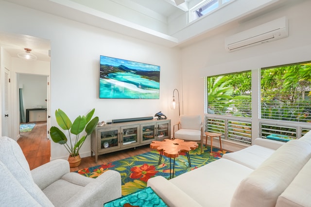 living room with a high ceiling, hardwood / wood-style floors, and a wall mounted AC