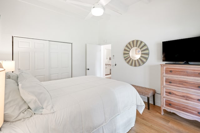 bedroom with beamed ceiling, ceiling fan, a closet, and light hardwood / wood-style flooring