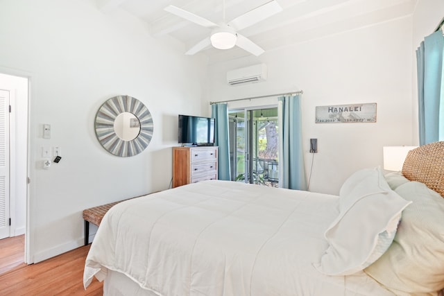 bedroom featuring an AC wall unit, access to exterior, hardwood / wood-style flooring, beamed ceiling, and ceiling fan