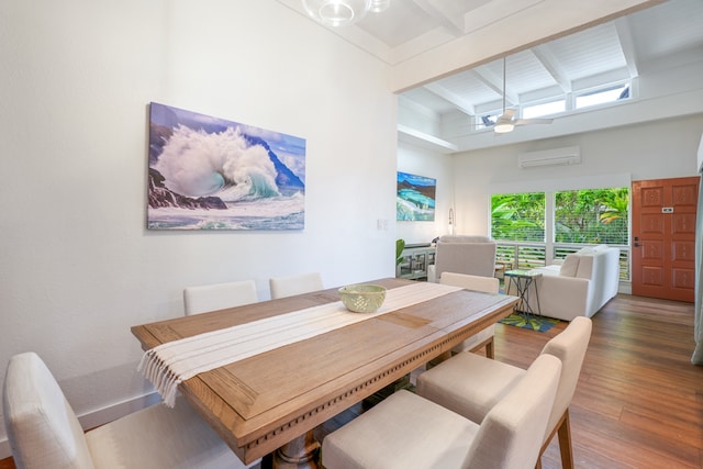 dining room featuring ceiling fan, hardwood / wood-style flooring, a wall mounted AC, and beamed ceiling