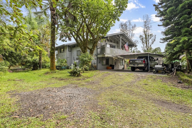 exterior space with a front lawn and a carport