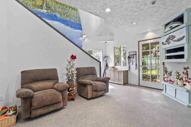 living area featuring a textured ceiling