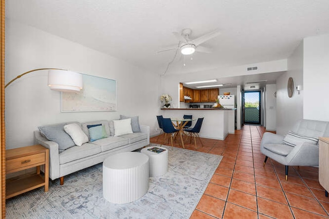 living room with ceiling fan and light tile patterned flooring