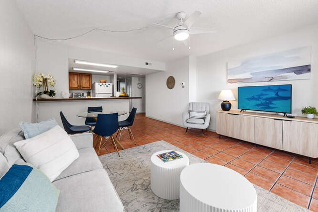 living room featuring ceiling fan and light tile patterned floors