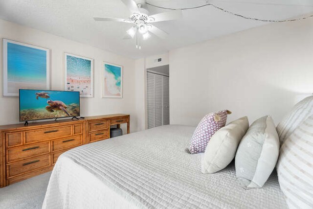 bedroom with carpet floors, a closet, and ceiling fan