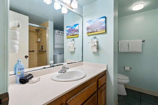 bathroom featuring tile patterned floors, stacked washer and dryer, toilet, a shower with door, and vanity