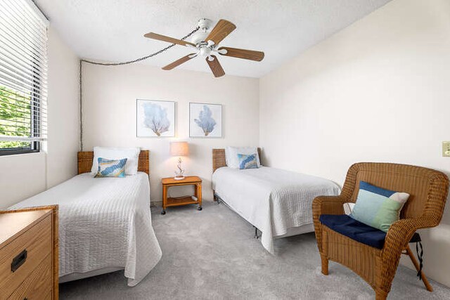 bedroom featuring light carpet and ceiling fan