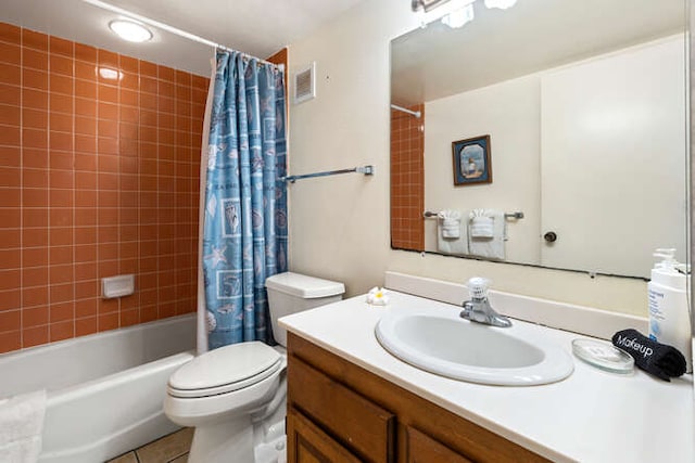 full bathroom with tile patterned flooring, shower / bath combo, toilet, and vanity