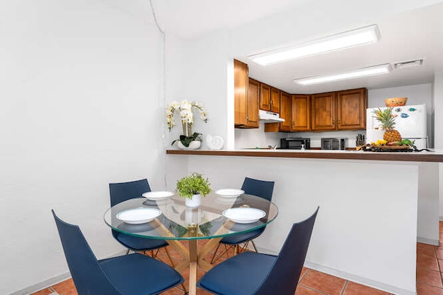 dining area featuring light tile patterned flooring