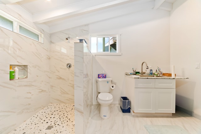 bathroom with tiled shower, vaulted ceiling with beams, toilet, and plenty of natural light