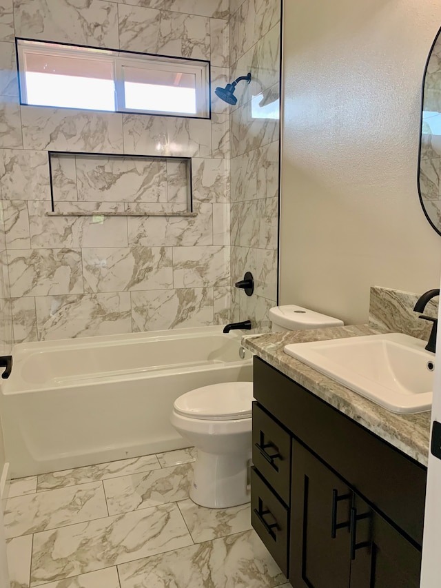 full bathroom featuring vanity, tiled shower / bath combo, toilet, and plenty of natural light