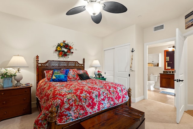 carpeted bedroom with ensuite bath, ceiling fan, a closet, and sink