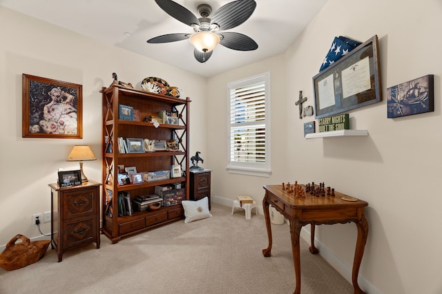 interior space featuring light carpet and ceiling fan