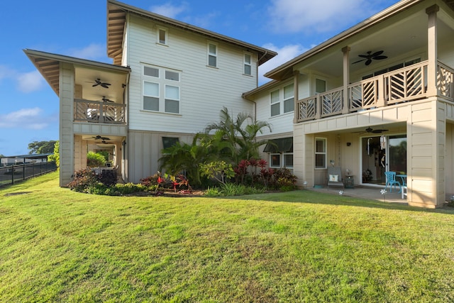 rear view of house with a lawn, ceiling fan, and a balcony