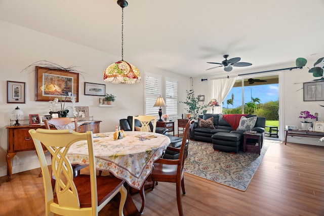 dining space with ceiling fan and light hardwood / wood-style floors