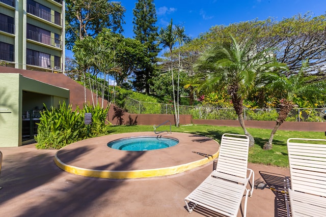 view of swimming pool with a patio and a hot tub