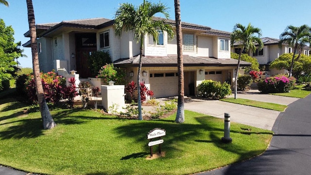 view of front of house with a garage and a front yard