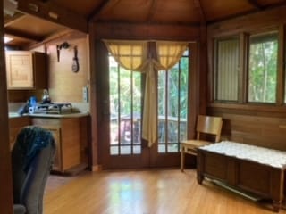 interior space with beam ceiling, wood walls, light hardwood / wood-style flooring, and wood ceiling