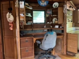 home office with hardwood / wood-style floors and built in desk