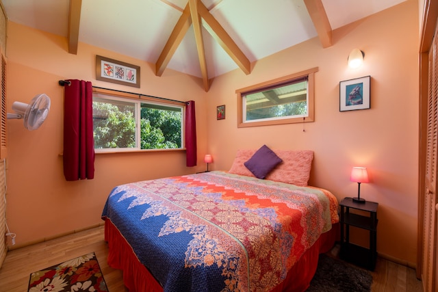 bedroom featuring lofted ceiling with beams and wood-type flooring