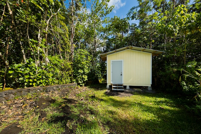 view of outbuilding featuring a lawn