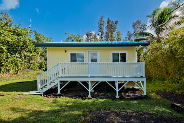 rear view of house featuring a yard and a wooden deck