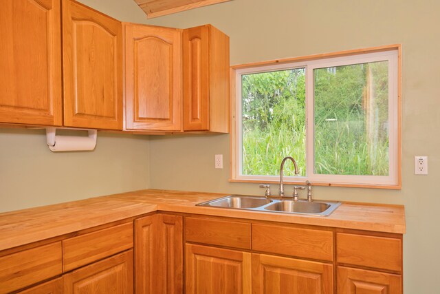 kitchen featuring beamed ceiling and sink