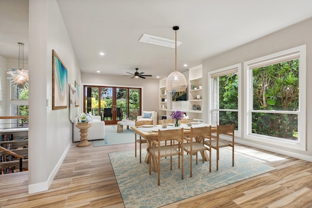 dining room featuring ceiling fan, plenty of natural light, french doors, and light hardwood / wood-style flooring