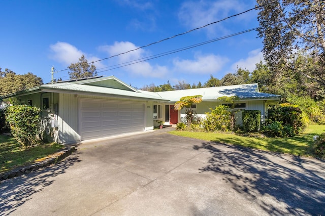 single story home featuring a garage and a front lawn