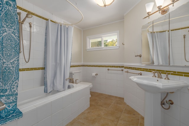 full bathroom featuring tile patterned flooring, shower / bath combination with curtain, toilet, tile walls, and ornamental molding