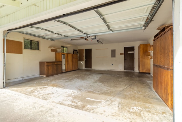 garage with electric panel and a garage door opener