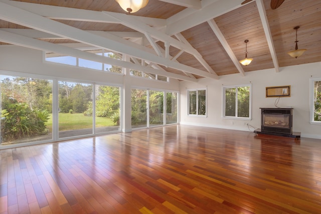 unfurnished living room with a fireplace, hardwood / wood-style floors, a wealth of natural light, and beamed ceiling