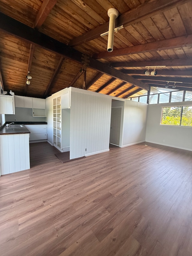 interior space with hardwood / wood-style floors, high vaulted ceiling, and wood walls