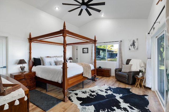 bedroom with light wood-type flooring, high vaulted ceiling, and ceiling fan