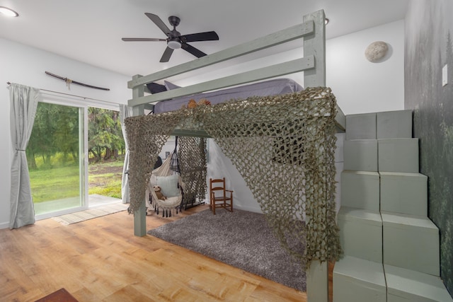 interior space featuring ceiling fan, plenty of natural light, and hardwood / wood-style flooring