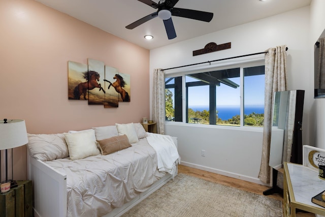 bedroom with light hardwood / wood-style flooring and ceiling fan